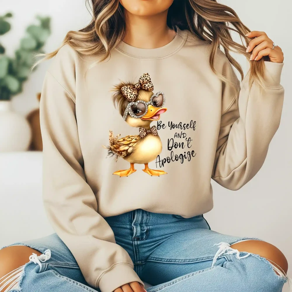 Girl wearing light brown sweatshirt with inspirational duck quote design
