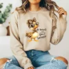 Girl wearing light brown sweatshirt with inspirational duck quote design