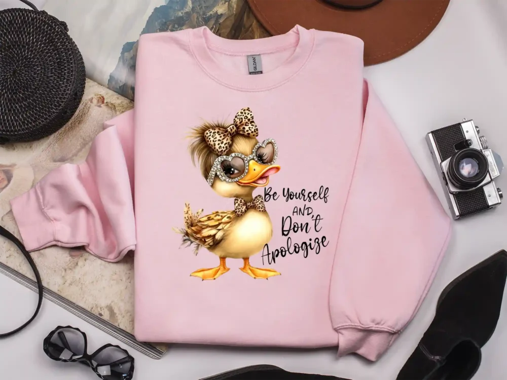 Light pink sweatshirt with Be Yourself And Don’t Apologize PNG print