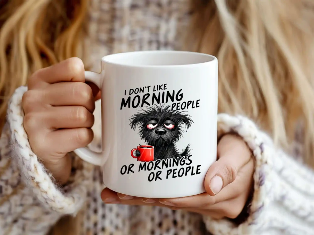 Woman holding white coffee mug with a grumpy dog design