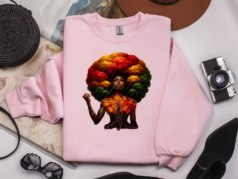 Light pink sweatshirt displaying afrocentric empowerment artwork