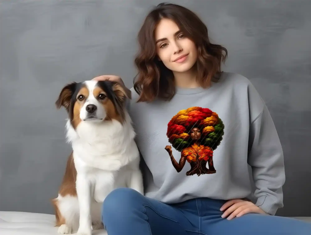 Girl sitting with dog wearing grey sweatshirt with afro inspired artwork