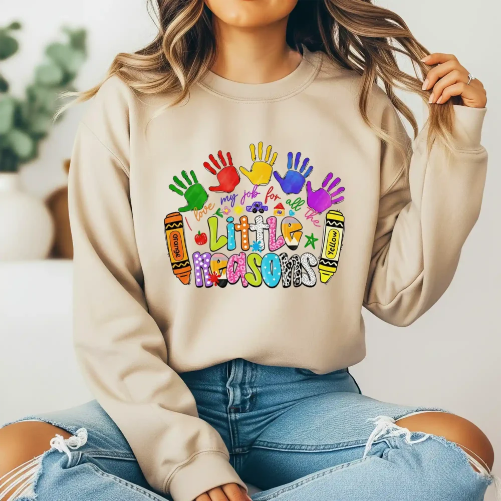 Girl wearing a brown sweatshirt with a school sublimation design