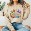 Girl wearing a brown sweatshirt with a school sublimation design