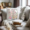 Decorative spring pillow with a watercolor bunny ear bow design