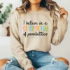 Girl wearing a tan sweatshirt with the Spectrum of Possibilities