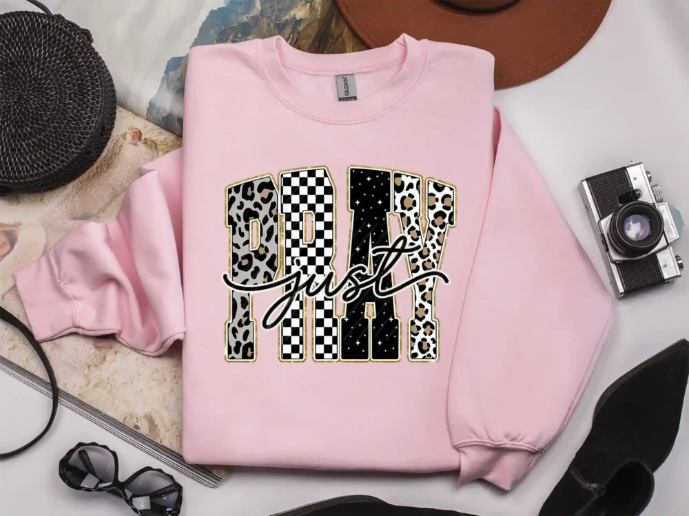 Light pink sweatshirt with varsity faith graphic