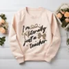 Blush pink sweatshirt with the Literally Just a Teacher PNG