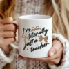 White coffee mug featuring the Literally Just a Teacher PNG