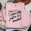 Light pink sweatshirt featuring the Literally Just a Teacher PNG