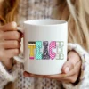 White coffee cup featuring the Neon Checkered TEACH PNG