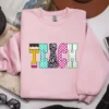 Light pink sweatshirt featuring the Neon Checkered TEACH PNG