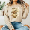 Girl wearing sweatshirt with stacked highland cow graphic