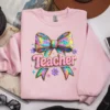 Rainbow Knitted Teacher PNG featured on a light pink top