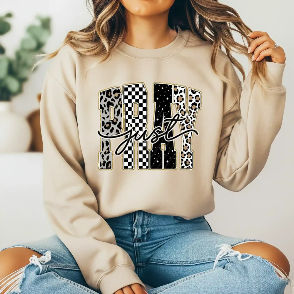Girl wearing light brown sweatshirt with checkered pray design