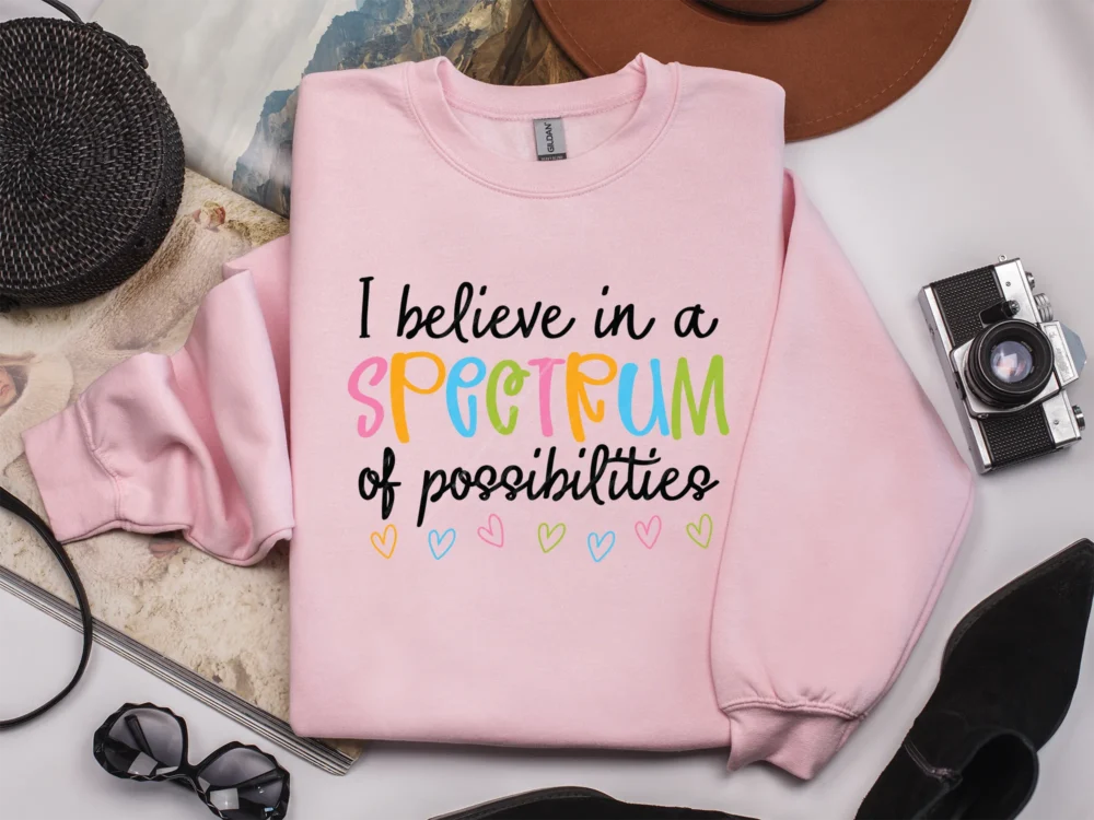 Pastel pink sweatshirt with a Spectrum of Possibilities PNG