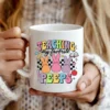 White coffee mug featuring a retro Easter teacher design