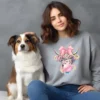 Girl sitting with dog wearing grey sweatshirt with cute cow design
