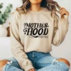 Girl wearing a tan hoodie with a cool mom club svg graphic