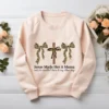 Coquette Christian Mama PNG printed on a blush sweatshirt