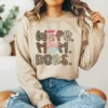 Girl wearing a light brown sweatshirt with a funny mom png graphic