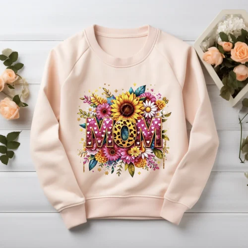 Blush pink sweatshirt displaying a watercolor mama PNG with pink glitter letters