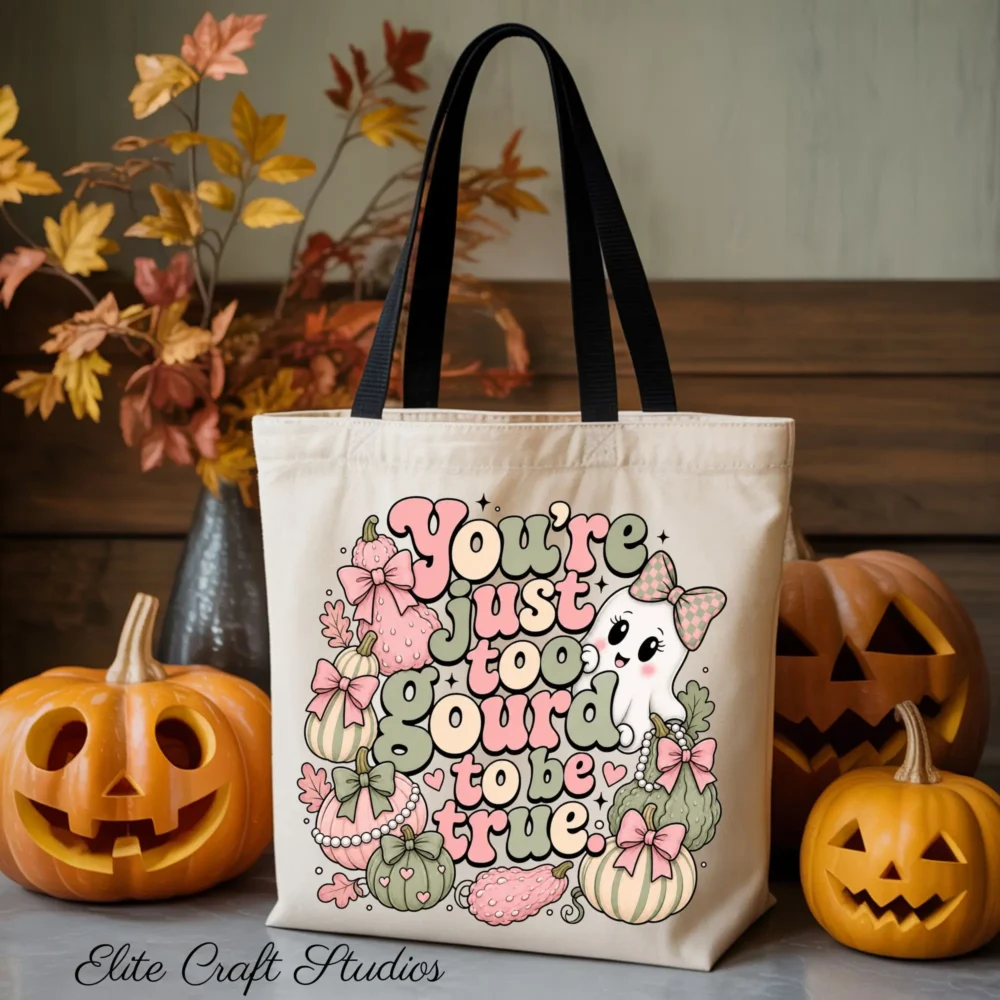 A canvas tote bag mock-up displaying a retro coquette halloween sublimation design that reads You're just too gourd to be true with pastel pumpkins, bows, and a cute ghost next to jack-o'-lanterns.