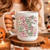 A close-up of a coffee mug featuring a coquette halloween sublimation PNG design that says Hocus Pocus I need candy to focus with candy corn and a pink bow ghost.