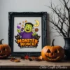An ornate black picture frame sitting on a rustic wooden table displays a colorful Frankenstein Monster Munch Halloween poster, flanked by carved jack-o'-lantern pumpkins and autumn leaves.