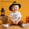 Happy toddler wearing a black witch hat and striped pants, showcasing a white t-shirt mockup with retro Halloween SVG graphic print against a yellow background.