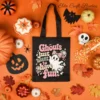 Black canvas trick-or-treat tote bag featuring the retro pink ghost graphic surrounded by festive Halloween decorations.