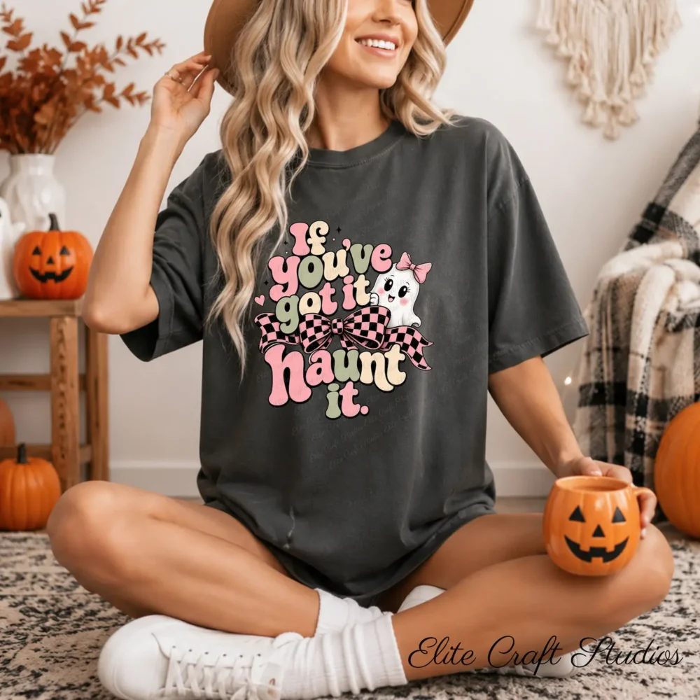A woman wearing an oversized dark grey t-shirt holding a pumpkin-shaped coffee mug