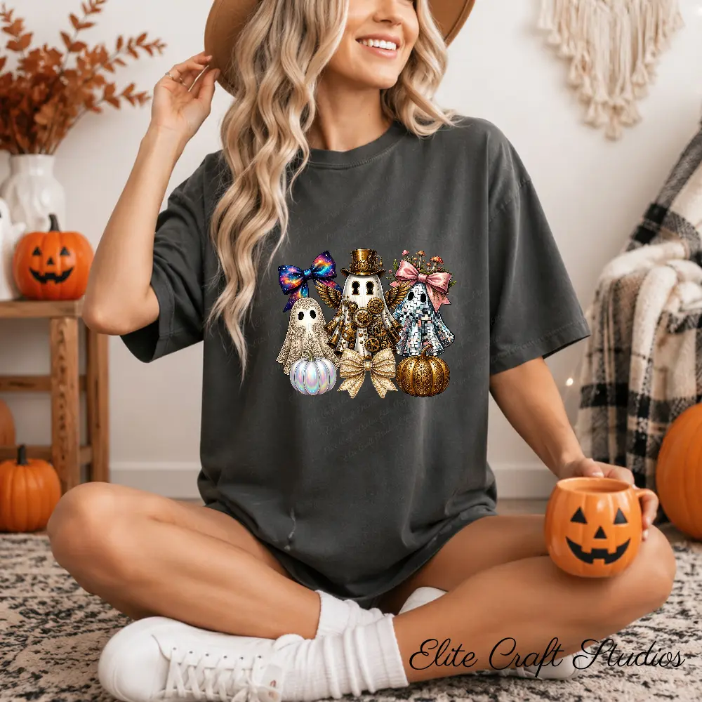 Model sitting cross-legged wearing a charcoal t-shirt printed with a steampunk ghost PNG design, holding a pumpkin mug in a cozy Halloween setting.