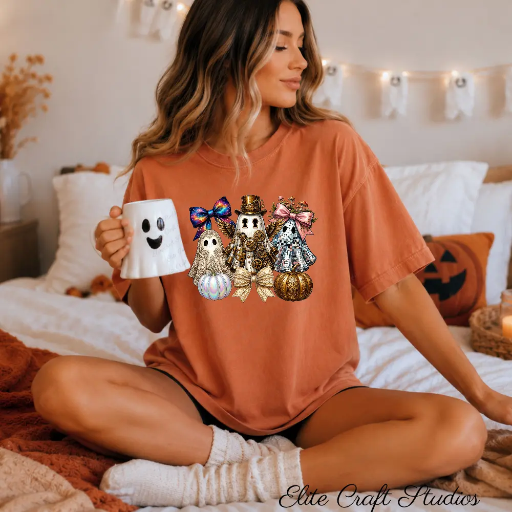 Model sitting on a bed wearing a terracotta t-shirt with a steampunk ghost PNG halloween sublimation design, holding a white ghost coffee mug.