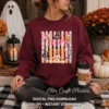 Woman sitting outside on steps wearing a dark maroon crewneck sweatshirt with the Creepy and Cute design holding a coffee cup next to pumpkins.