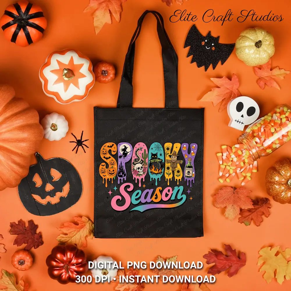 Flat lay view of a black tote bag printed with the Spooky Season design, surrounded by scattered autumn leaves, miniature pumpkins, and candy corn.
