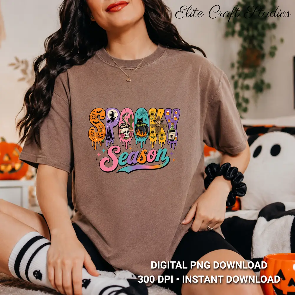 Model wearing a neutral brown casual t-shirt printed with the retro dripping Spooky Season design, seated near fall decor.