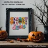Ornate black vintage frame displaying the Spooky Season art print on a wooden mantel between two carved jack-o'-lanterns.