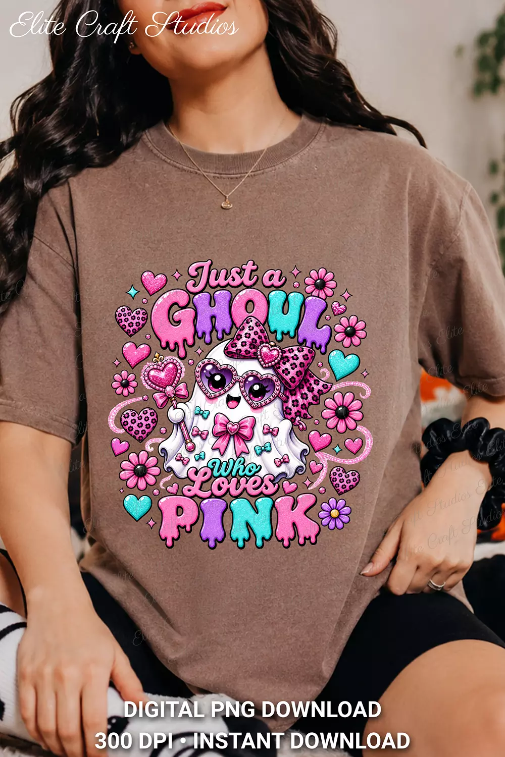 Model in a faded taupe brown t-shirt showcasing the Just a Ghoul Who Loves Pink graphic with leopard accents and floral details.