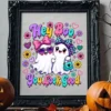 Ornate black picture frame containing the Hey Boo ghost design displayed on a rustic wooden table between two carved jack-o-lanterns.