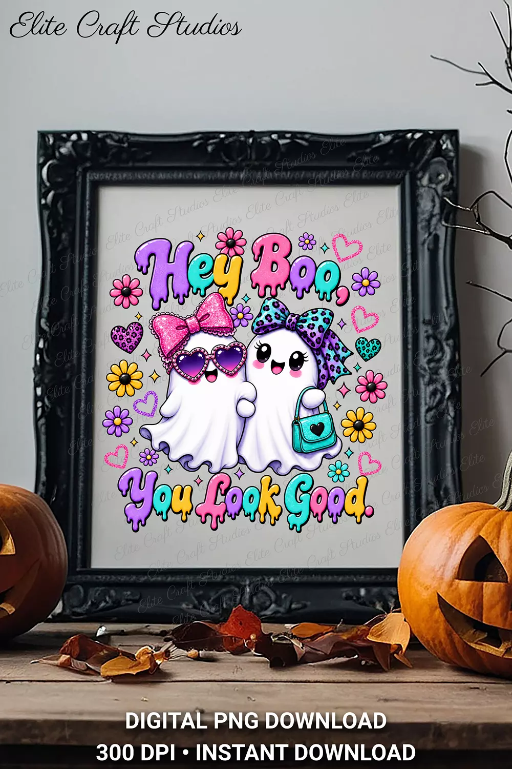 Ornate black picture frame containing the Hey Boo ghost design displayed on a rustic wooden table between two carved jack-o-lanterns.